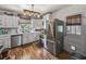 Well-lit kitchen with stainless steel appliances, white cabinets, and modern light fixtures at 3001 9Th N Ave, St Petersburg, FL 33713