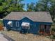 Rear exterior view of the home showing the blue siding, awning-covered windows, and screened-in back porch at 3001 9Th N Ave, St Petersburg, FL 33713