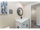 Stylish bathroom with a modern vanity, round mirror, and beach-themed decor at 3112 65Th N Way, St Petersburg, FL 33710
