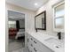 Bathroom features a double vanity with white countertops, black fixtures, and stylish patterned floor at 3112 65Th N Way, St Petersburg, FL 33710