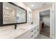 Bathroom with double vanity, quartz countertop, black hardware, and a glass-enclosed shower, a stylish and functional space at 3112 65Th N Way, St Petersburg, FL 33710