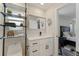 Bright bathroom featuring a floating shelving unit, and a modern vanity with black hardware at 3112 65Th N Way, St Petersburg, FL 33710