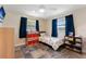Bright bedroom features wood-look flooring, ceiling fan, storage shelves, and a colorful area rug at 3112 65Th N Way, St Petersburg, FL 33710