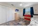 Cozy bedroom features wood floors, ample storage, a TV, and a bright window, creating a comfortable and inviting space at 3112 65Th N Way, St Petersburg, FL 33710