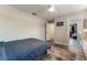 Cozy bedroom with wood-look floors and a comfortable bed, illuminated by a ceiling fan and recessed lighting at 3112 65Th N Way, St Petersburg, FL 33710