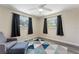 Bedroom includes wood-look flooring, natural lighting, and a blue geometric area rug at 3112 65Th N Way, St Petersburg, FL 33710