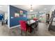 Dining room with red accent chair, wooden table, and view into other living spaces at 3112 65Th N Way, St Petersburg, FL 33710