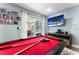 Game room featuring a pool table, TV, and sliding door access to the backyard pool area at 3112 65Th N Way, St Petersburg, FL 33710