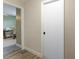 Hallway leading to an office space with a desk, chair, and neutral walls at 3112 65Th N Way, St Petersburg, FL 33710