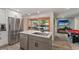 Modern kitchen featuring white cabinets, stainless steel appliances, and an island with seating at 3112 65Th N Way, St Petersburg, FL 33710
