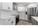 Modern kitchen featuring white cabinets, stainless steel appliances, and subway tile backsplash at 3112 65Th N Way, St Petersburg, FL 33710