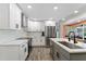 Modern kitchen featuring white cabinets, stainless steel appliances, and an island with sink at 3112 65Th N Way, St Petersburg, FL 33710
