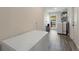 Functional laundry area with wood-look tile flooring and ample space for storage and appliances at 3112 65Th N Way, St Petersburg, FL 33710
