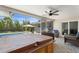 Relaxing screened-in patio with hot tub, outdoor furniture, and view of the backyard and pool at 3112 65Th N Way, St Petersburg, FL 33710