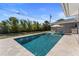 Long backyard pool with clear water, lounge chairs, and a covered patio area for relaxation at 3112 65Th N Way, St Petersburg, FL 33710
