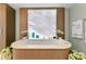 Luxurious soaking tub, framed by marble walls and accented with elegant floral decor at 3301 Bayshore Blvd # 2401E, Tampa, FL 33629
