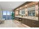 Bright bathroom with marble floors, double vanity, makeup station, and floor to ceiling windows at 3301 Bayshore Blvd # 2401E, Tampa, FL 33629