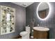Charming powder room featuring a vanity with a lighted mirror and a unique artwork piece at 3301 Bayshore Blvd # 2401E, Tampa, FL 33629
