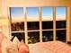 Bedroom with floor to ceiling windows overlooking city and a glimpse of a sunset at 3301 Bayshore Blvd # 2401E, Tampa, FL 33629