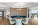 This dining area features an intimate booth with blue pillows under a modern chandelier with hardwood floors at 3301 Bayshore Blvd # 2401E, Tampa, FL 33629
