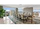 Luxury dining room with large windows, city views, modern lighting, and seating for twelve at 3301 Bayshore Blvd # 2401E, Tampa, FL 33629