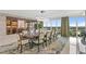 Elegant dining room with modern lighting, large windows with cityscape views, and adjacent custom wine storage at 3301 Bayshore Blvd # 2401E, Tampa, FL 33629