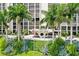 Beautifully landscaped Monte Carlo Towers with palm trees, lush greenery, and a welcoming entrance at 3301 Bayshore Blvd # 2401E, Tampa, FL 33629