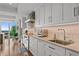 Stylish kitchen with white cabinets, stainless steel appliances, stone countertops and backsplash at 3301 Bayshore Blvd # 2401E, Tampa, FL 33629