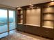 Living room features custom built-ins with marble counters and a wall of windows at 3301 Bayshore Blvd # 2401E, Tampa, FL 33629