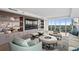 The elegant living room includes custom built ins, a large flat screen television, and expansive windows at 3301 Bayshore Blvd # 2401E, Tampa, FL 33629