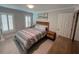 Comfortable bedroom with a bed, shutters, and wooden furniture, creating a relaxing and inviting atmosphere at 333 Island Way # 203, Clearwater Beach, FL 33767