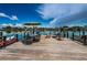Private dock with an umbrella covered table, seating area, and views of the water at 333 Island Way # 203, Clearwater Beach, FL 33767