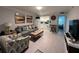 Inviting living room with sofa, chair, kitchen view, and decorative wall art, offering a comfortable living space at 333 Island Way # 203, Clearwater Beach, FL 33767