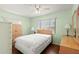 Bright bedroom featuring a ceiling fan, light green walls, and two large windows at 3545 97Th N Ave # 4, Pinellas Park, FL 33782