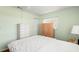Bright bedroom featuring wood furnishings, a white comforter, and a large window at 3545 97Th N Ave # 4, Pinellas Park, FL 33782