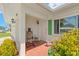 Charming front porch with a rocking chair and decorative tile flooring, offering a warm welcome at 3545 97Th N Ave # 4, Pinellas Park, FL 33782