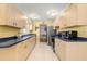 Bright kitchen features ample cabinet space, modern appliances, and a seamless flow to the dining area at 3545 97Th N Ave # 4, Pinellas Park, FL 33782