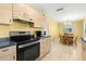 Kitchen area featuring modern appliances, wood cabinets, and a cozy adjacent dining area at 3545 97Th N Ave # 4, Pinellas Park, FL 33782