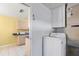 Laundry room featuring a white washer, blue countertops, and yellow accent wall at 3545 97Th N Ave # 4, Pinellas Park, FL 33782