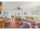 Spacious living room with hardwood floors, comfortable seating, and a view into the dining area at 3545 97Th N Ave # 4, Pinellas Park, FL 33782