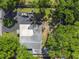 Overhead view of the property with mature trees, a large roof, and a circular driveway at 3910 W Comanche Ave, Tampa, FL 33614