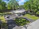 Aerial view of the home featuring a circular driveway and lush landscaping at 3910 W Comanche Ave, Tampa, FL 33614