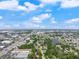 Scenic aerial view showcasing the property's location with nearby lake, highway, and commercial areas at 3910 W Comanche Ave, Tampa, FL 33614
