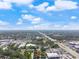 Wide aerial view revealing the property's proximity to highways, shopping centers, and surrounding neighborhoods at 3910 W Comanche Ave, Tampa, FL 33614