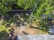 Aerial view of a spacious backyard featuring lush greenery and mature trees casting shadows at 3910 W Comanche Ave, Tampa, FL 33614