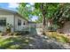 Backyard with a mix of grass, gravel, and plants at 3910 W Comanche Ave, Tampa, FL 33614