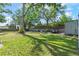 Expansive backyard features a lush lawn, mature trees and plenty of space for outdoor activities at 3910 W Comanche Ave, Tampa, FL 33614