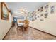 Comfortable dining room with tile flooring, a ceiling fan, and walls decorated with a collection of photos at 3910 W Comanche Ave, Tampa, FL 33614