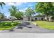 Front of the home with a long driveway and landscaping at 3910 W Comanche Ave, Tampa, FL 33614