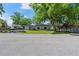 Inviting single-story home surrounded by mature trees and lush greenery, offering a tranquil setting at 3910 W Comanche Ave, Tampa, FL 33614